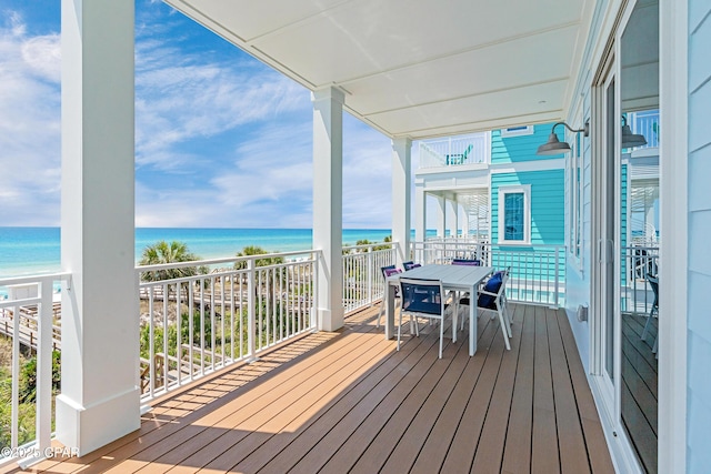 13643 Front Beach Rd, Panama City Beach, FL 32413 - wooden deck with view of water and beach and outdoor dining space