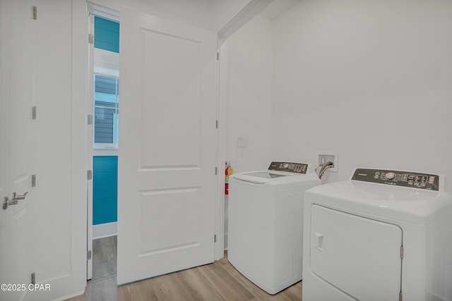 13643 Front Beach Rd, Panama City Beach, FL 32413 - washroom with washing machine and clothes dryer and light wood-type flooring
