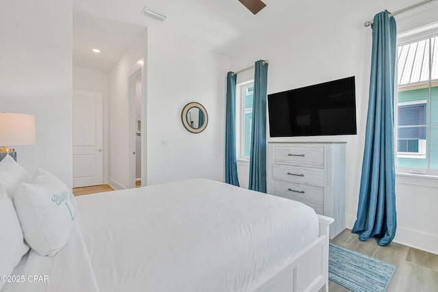 13643 Front Beach Rd, Panama City Beach, FL 32413 - bedroom with multiple windows, light wood-style flooring, and ceiling fan
