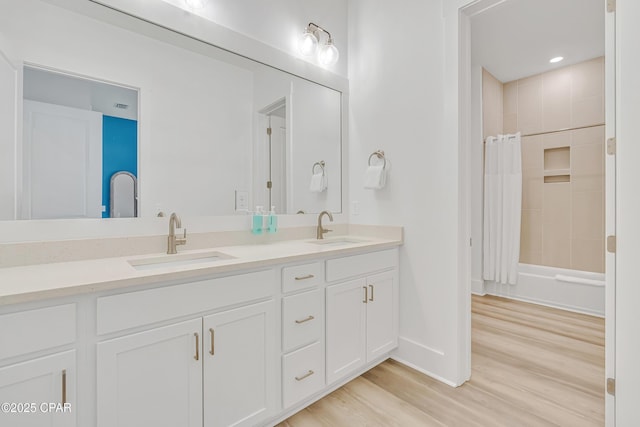 13643 Front Beach Rd, Panama City Beach, FL 32413 - full bathroom with double vanity, wood finished floors, and shower / bath combo