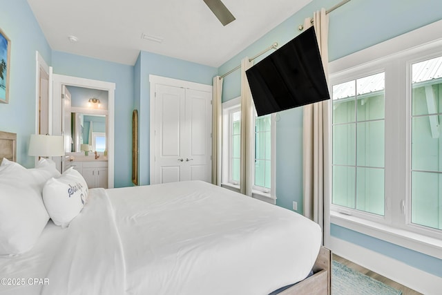 13643 Front Beach Rd, Panama City Beach, FL 32413 - bedroom with a closet, wood finished floors, ensuite bath, and a ceiling fan