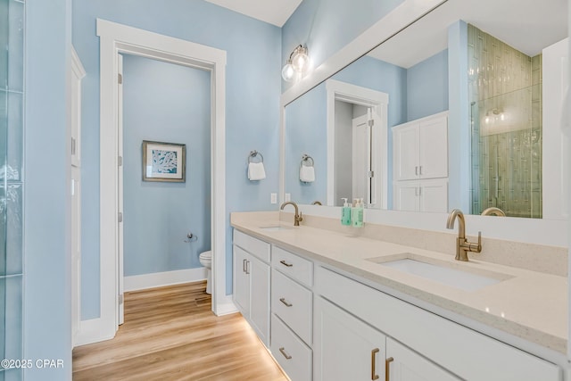13643 Front Beach Rd, Panama City Beach, FL 32413 - bathroom featuring double vanity, a shower stall, and wood finished floors