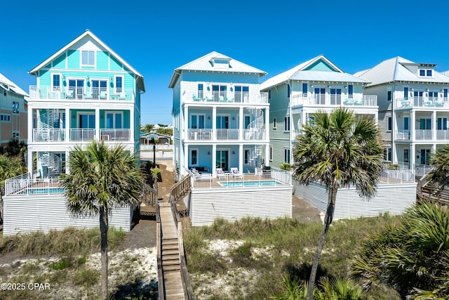 13643 Front Beach Rd, Panama City Beach, FL 32413 - back of property with a balcony, an outdoor pool, and a patio area
