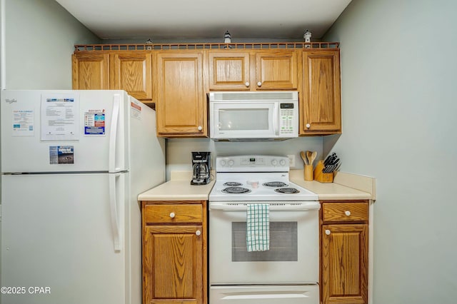 kitchen featuring white appliances, brown cabinetry, and light countertops