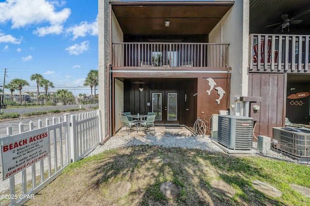 back of house featuring french doors, ceiling fan, central AC unit, and a balcony