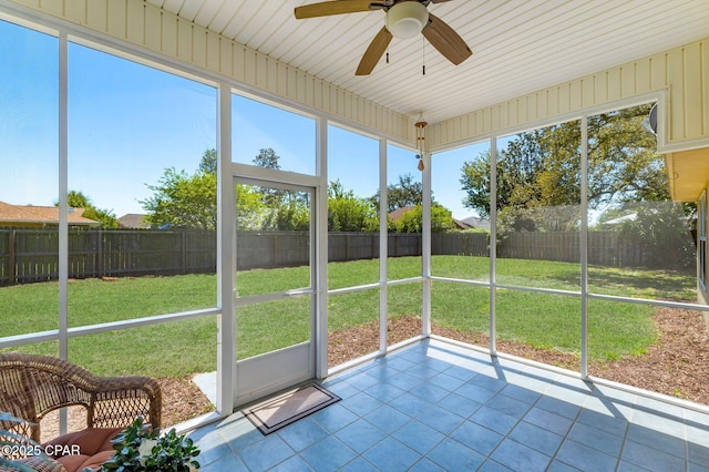 unfurnished sunroom featuring a ceiling fan