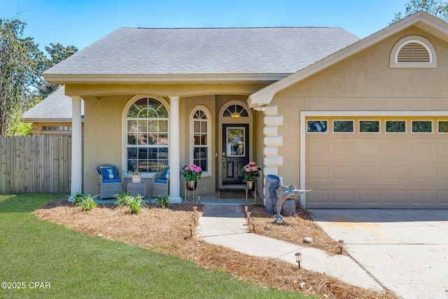 doorway to property with roof with shingles, stucco siding, fence, and an attached garage