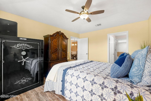 bedroom featuring visible vents, a ceiling fan, and wood finished floors