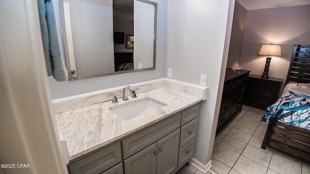 ensuite bathroom with vanity, tile patterned flooring, and connected bathroom