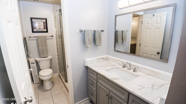 full bath featuring toilet, baseboards, tile patterned flooring, a shower stall, and vanity