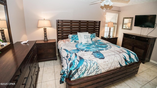 bedroom with ceiling fan and light tile patterned floors