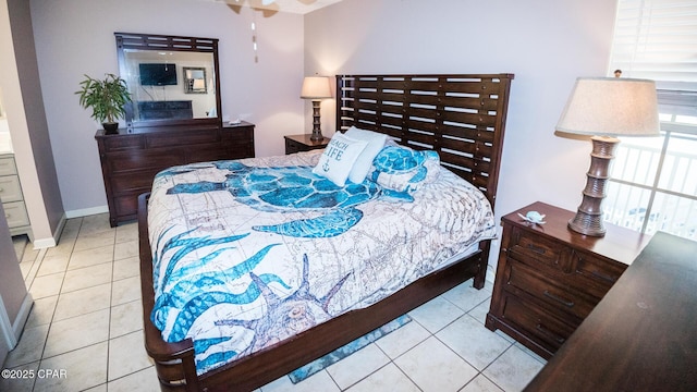 bedroom with tile patterned floors and baseboards
