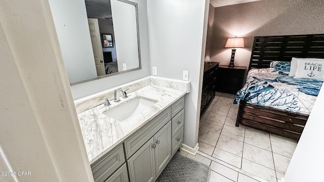 ensuite bathroom featuring tile patterned floors, vanity, and ensuite bathroom