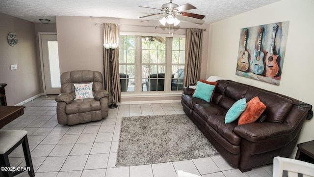 living room featuring tile patterned flooring, a ceiling fan, and a textured ceiling