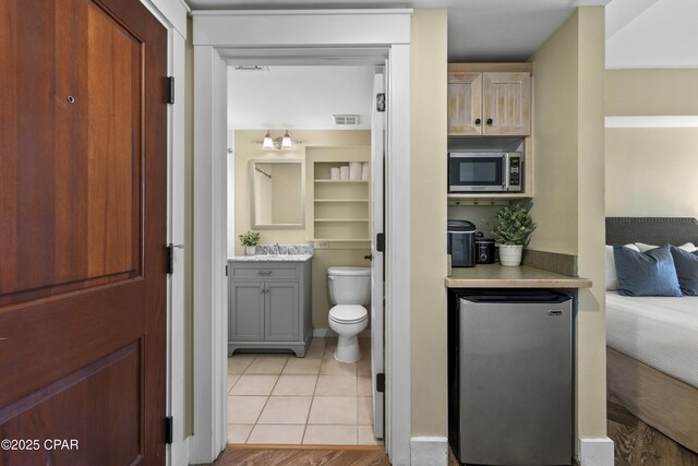 9300 Baytowne Wharf Blvd Unit 528/530, Miramar Beach, FL 32550 - bathroom featuring toilet, vanity, and tile patterned flooring