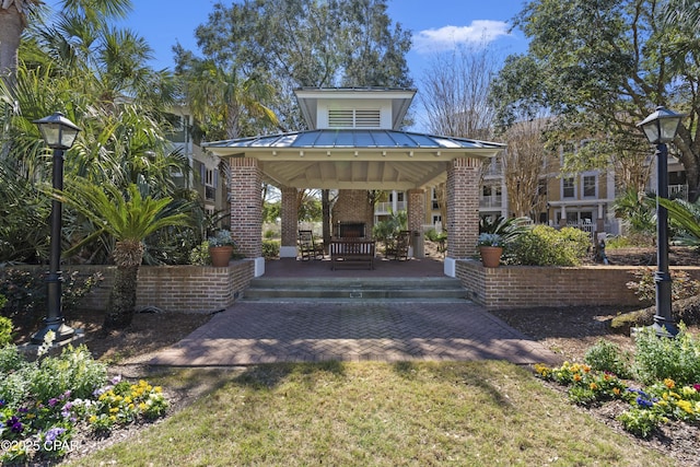 9300 Baytowne Wharf Blvd Unit 528/530, Miramar Beach, FL 32550 - view of front of home featuring a gazebo, brick siding, metal roof, and a standing seam roof