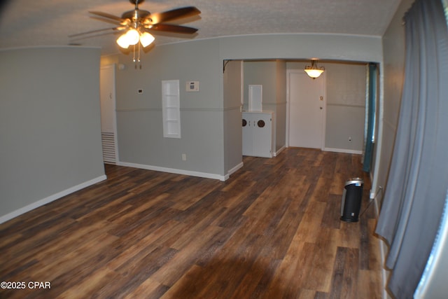 unfurnished room featuring dark wood finished floors, ceiling fan, and baseboards
