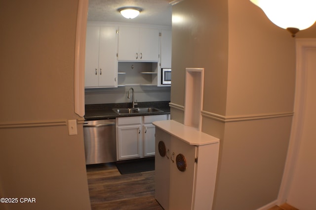 kitchen with white cabinets, stainless steel appliances, open shelves, and a sink