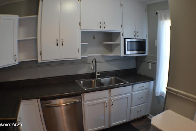 kitchen featuring appliances with stainless steel finishes, open shelves, a sink, and white cabinetry
