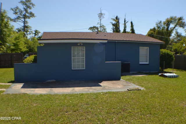 back of house with a lawn, a patio, and fence