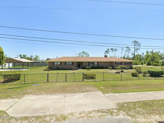 ranch-style house featuring fence and a front yard
