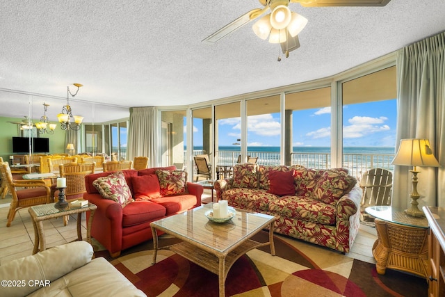 10509 Front Beach Rd Unit 300, Panama City Beach, FL 32407 - living room with a ceiling fan, a water view, a textured ceiling, and plenty of natural light