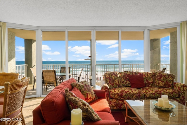 10509 Front Beach Rd Unit 300, Panama City Beach, FL 32407 - living room with a wall of windows, a textured ceiling, and a water view