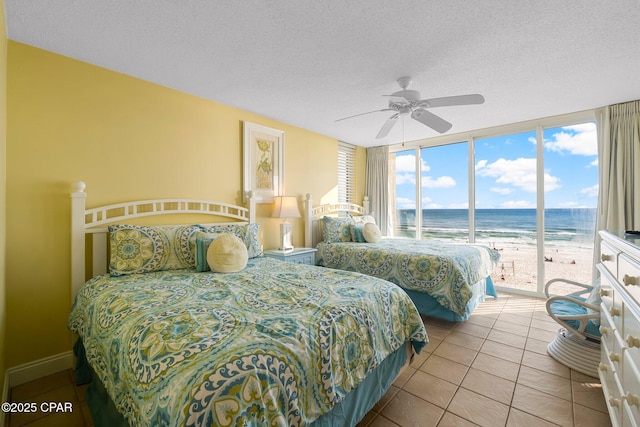 10509 Front Beach Rd Unit 300, Panama City Beach, FL 32407 - bedroom with access to exterior, a water view, a textured ceiling, and a view of the beach