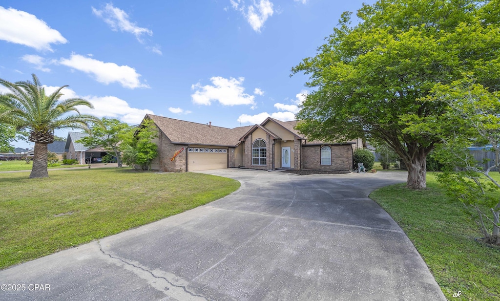 ranch-style house with a garage, driveway, a front lawn, and brick siding