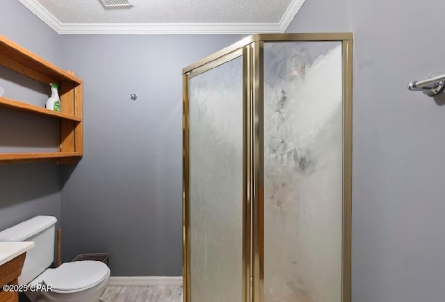 full bathroom featuring visible vents, toilet, vanity, crown molding, and a stall shower