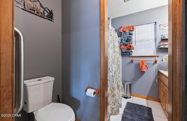 bathroom featuring tile patterned flooring, vanity, and toilet