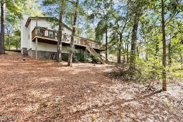 back of house with a wooden deck and stairway