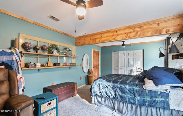 bedroom with beam ceiling, visible vents, carpet, a ceiling fan, and a closet