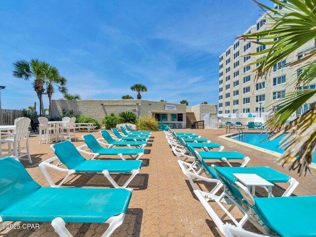 view of pool featuring fence and a patio area