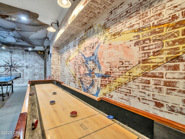 recreation room featuring brick wall, concrete flooring, and billiards