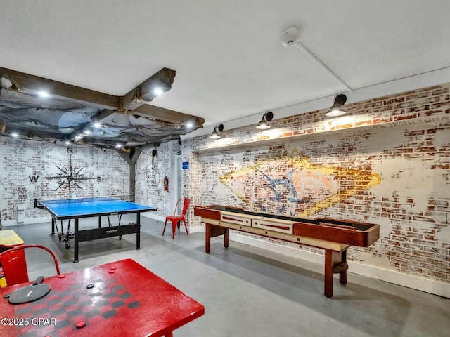 playroom with brick wall and concrete flooring
