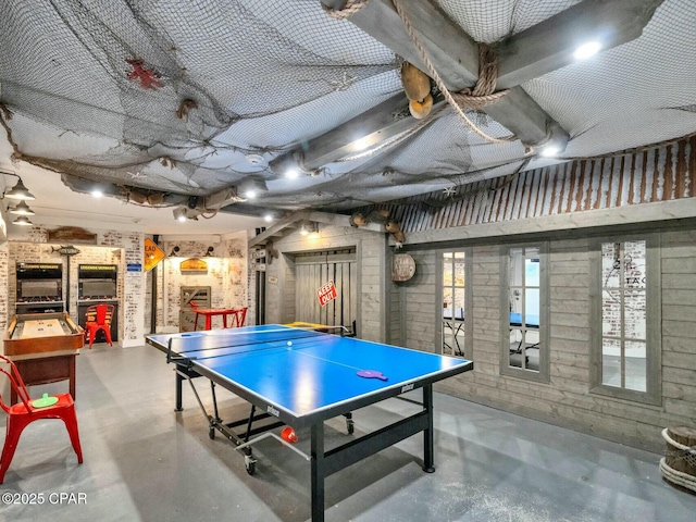 game room featuring finished concrete floors