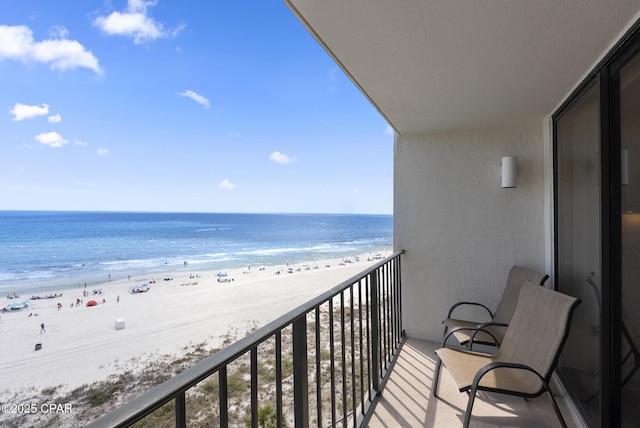 balcony featuring view of water and beach