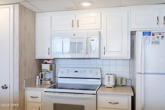 kitchen with white appliances, white cabinetry, tasteful backsplash, and light countertops