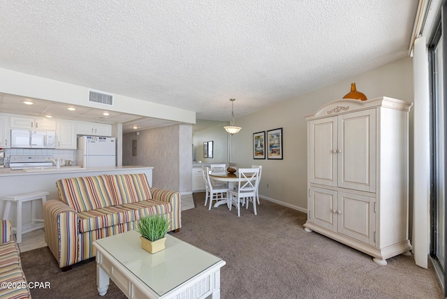 living room featuring light carpet, a textured ceiling, recessed lighting, and baseboards