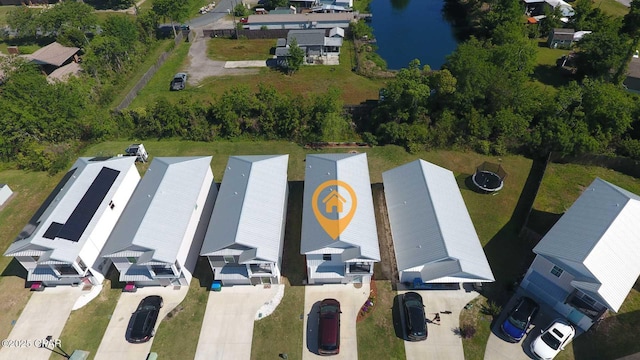 birds eye view of property with a residential view and a water view