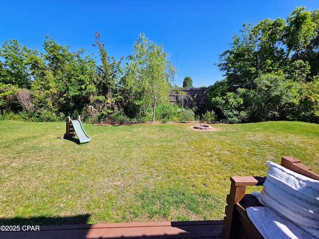 view of yard with an outdoor fire pit
