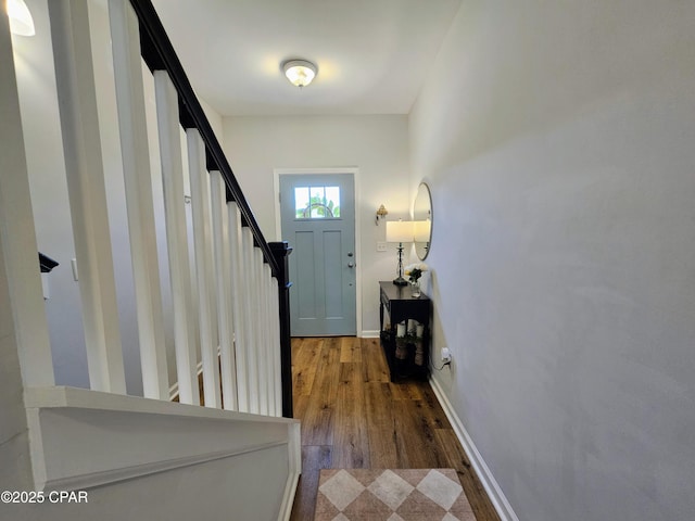 foyer featuring stairway, baseboards, and wood finished floors