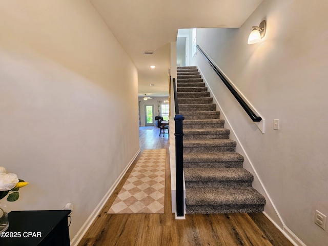 staircase featuring visible vents, baseboards, recessed lighting, a ceiling fan, and wood finished floors