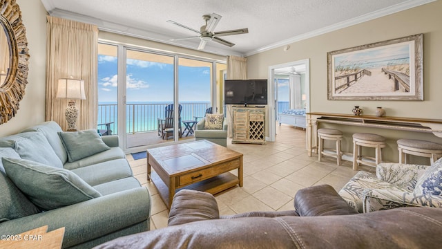 9450 S Thomas Dr Unit 1609C, Panama City Beach, FL 32408 - living room with ceiling fan, light tile patterned floors, crown molding, and a textured ceiling