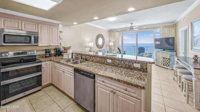 9450 S Thomas Dr Unit 1609C, Panama City Beach, FL 32408 - kitchen featuring appliances with stainless steel finishes, a peninsula, ornamental molding, light tile patterned floors, and a sink