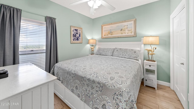 9450 S Thomas Dr Unit 1609C, Panama City Beach, FL 32408 - bedroom featuring light wood-type flooring, a ceiling fan, and baseboards