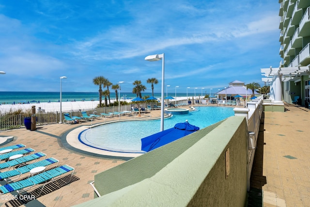 9450 S Thomas Dr Unit 1609C, Panama City Beach, FL 32408 - view of swimming pool featuring a gazebo, fence, a patio area, a water view, and a pool with connected hot tub