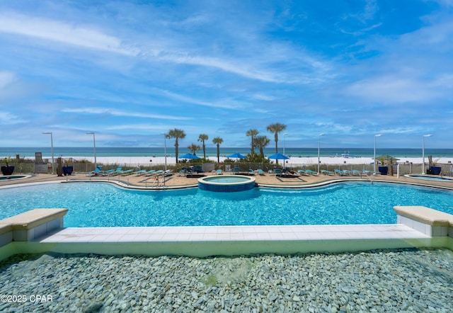 9450 S Thomas Dr Unit 1609C, Panama City Beach, FL 32408 - view of swimming pool with fence, a patio area, a pool with connected hot tub, and a water view