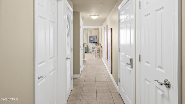 9450 S Thomas Dr Unit 1609C, Panama City Beach, FL 32408 - hallway featuring light tile patterned floors and baseboards